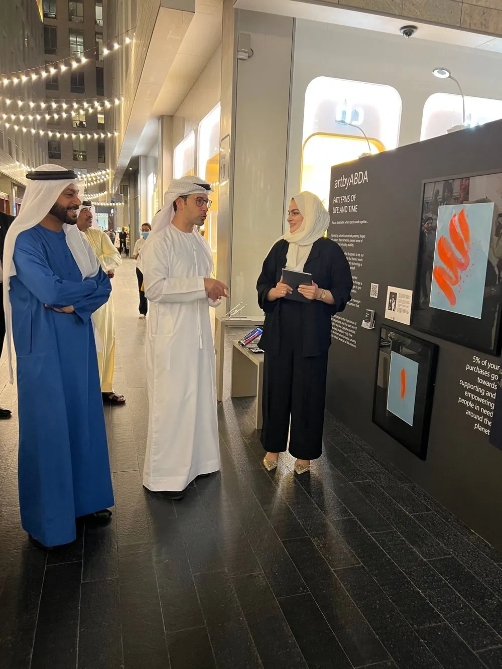Abda Fayyaz presenting her artworks at her DIFC Art Nights stand with guests